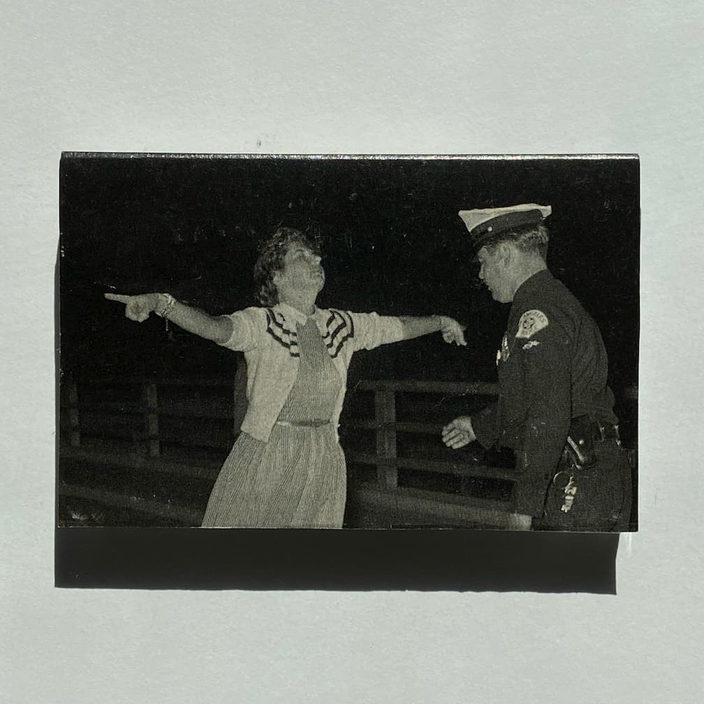 cassette front - woman with arms extended and eyes closed and policeman